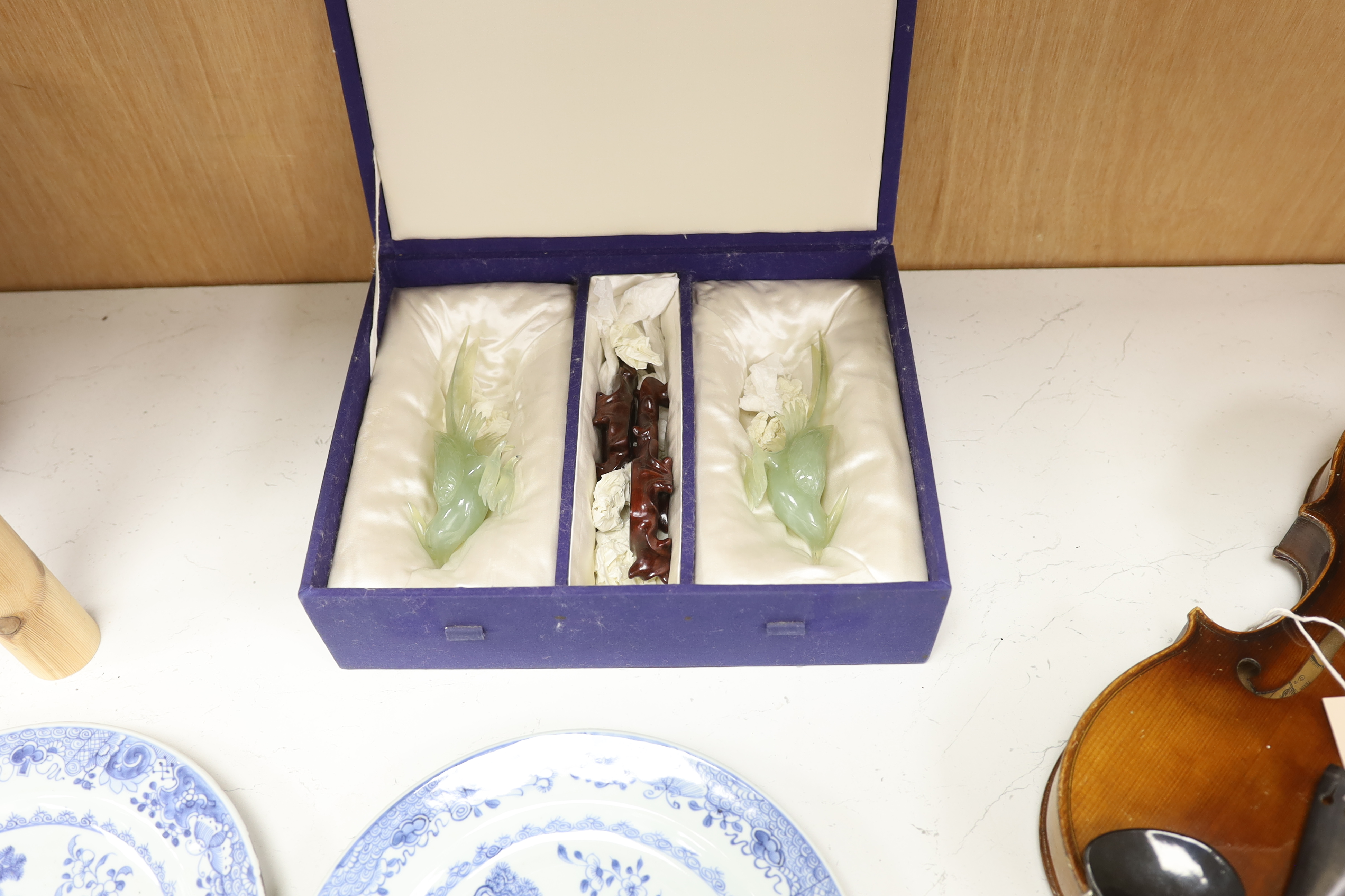 A pair of carved bowenite jade birds on stands, boxed